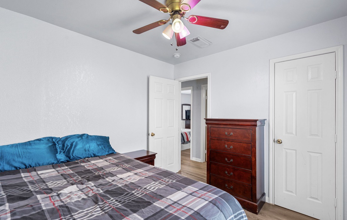 620 6th Street Dickinson, TX 77539 - Photo 23 of 36 a bedroom with a bed and a chandelier