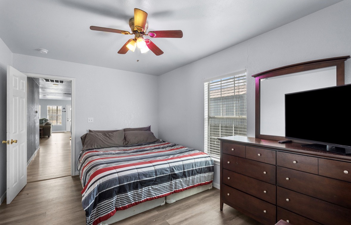 620 6th Street Dickinson, TX 77539 - Photo 27 of 36 a bedroom with a bed and a flat screen tv