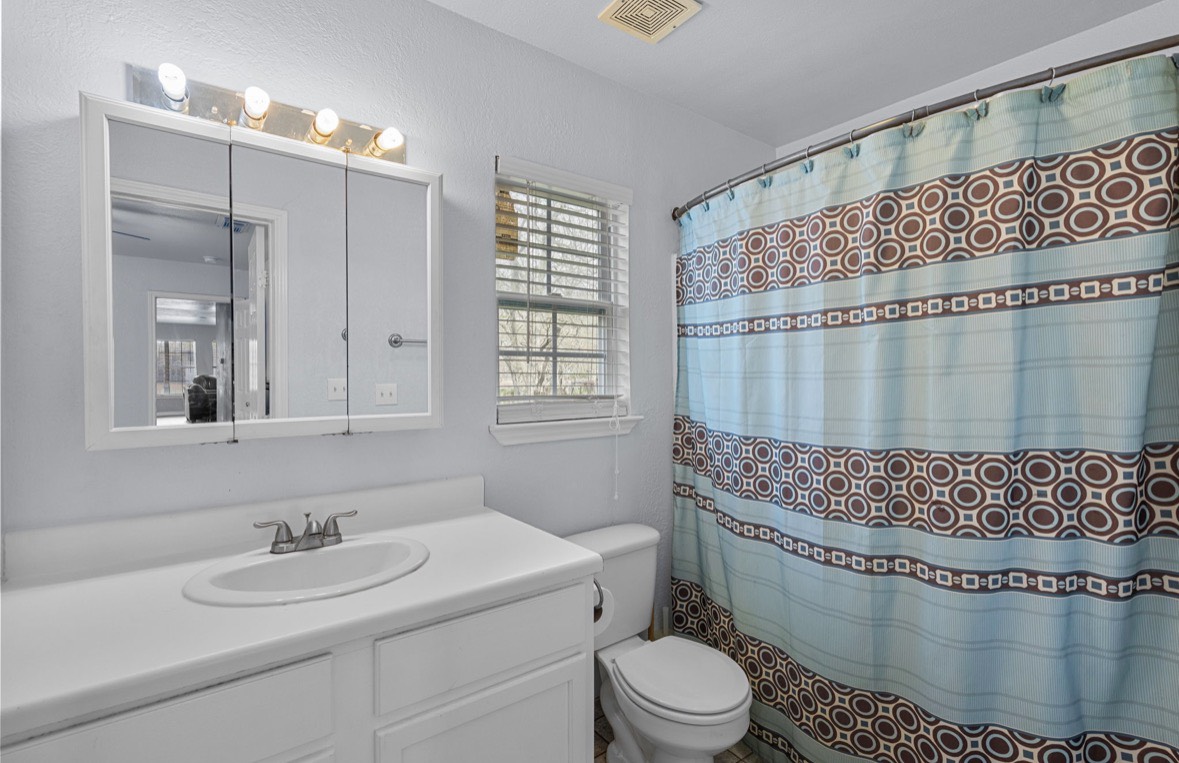 620 6th Street Dickinson, TX 77539 - Photo 28 of 36 a bathroom with a sink toilet and shower