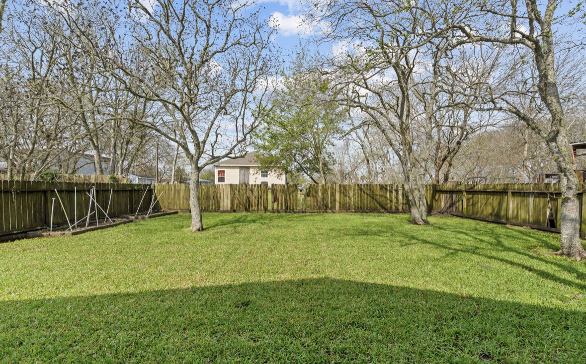 620 6th Street Dickinson, TX 77539 - Photo 30 of 36 a view of an house with backyard and trees
