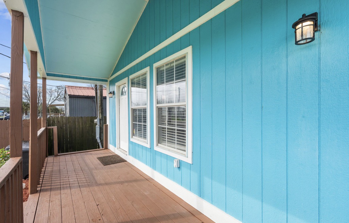 620 6th Street Dickinson, TX 77539 - Photo 6 of 36 a view of a porch with wooden floor and windows