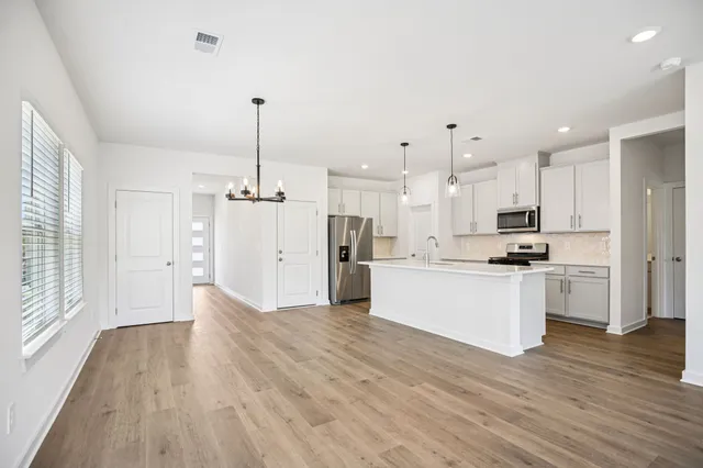 a view of a kitchen with wooden floor