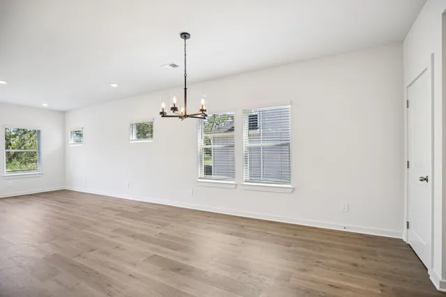 a view of a room with wooden floor