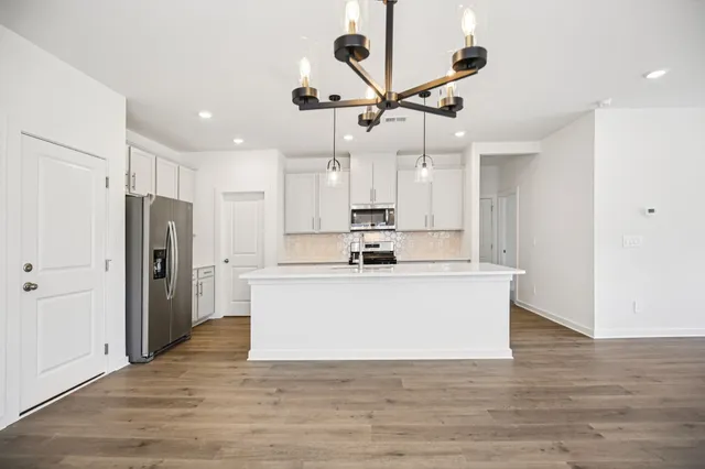 a kitchen with white cabinets stainless steel appliances and sink