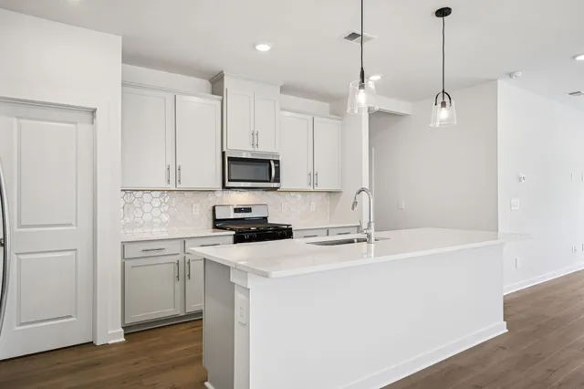 a bathroom with a granite countertop sink toilet and bathtub