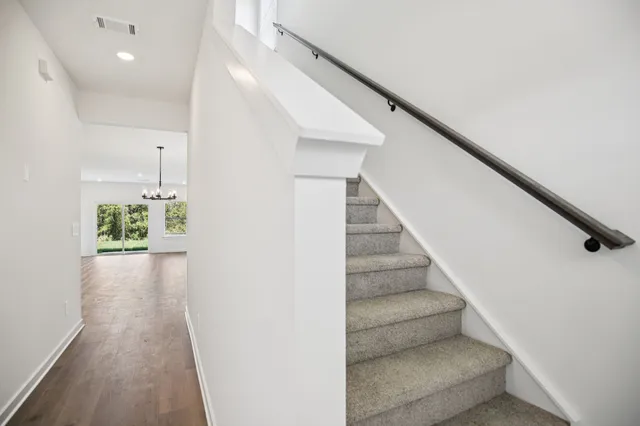 a view of entryway and hall with wooden floor