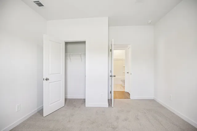 a front view of a house with a garden and yard