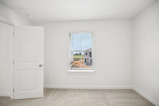 a view of a house with a yard and a large tree