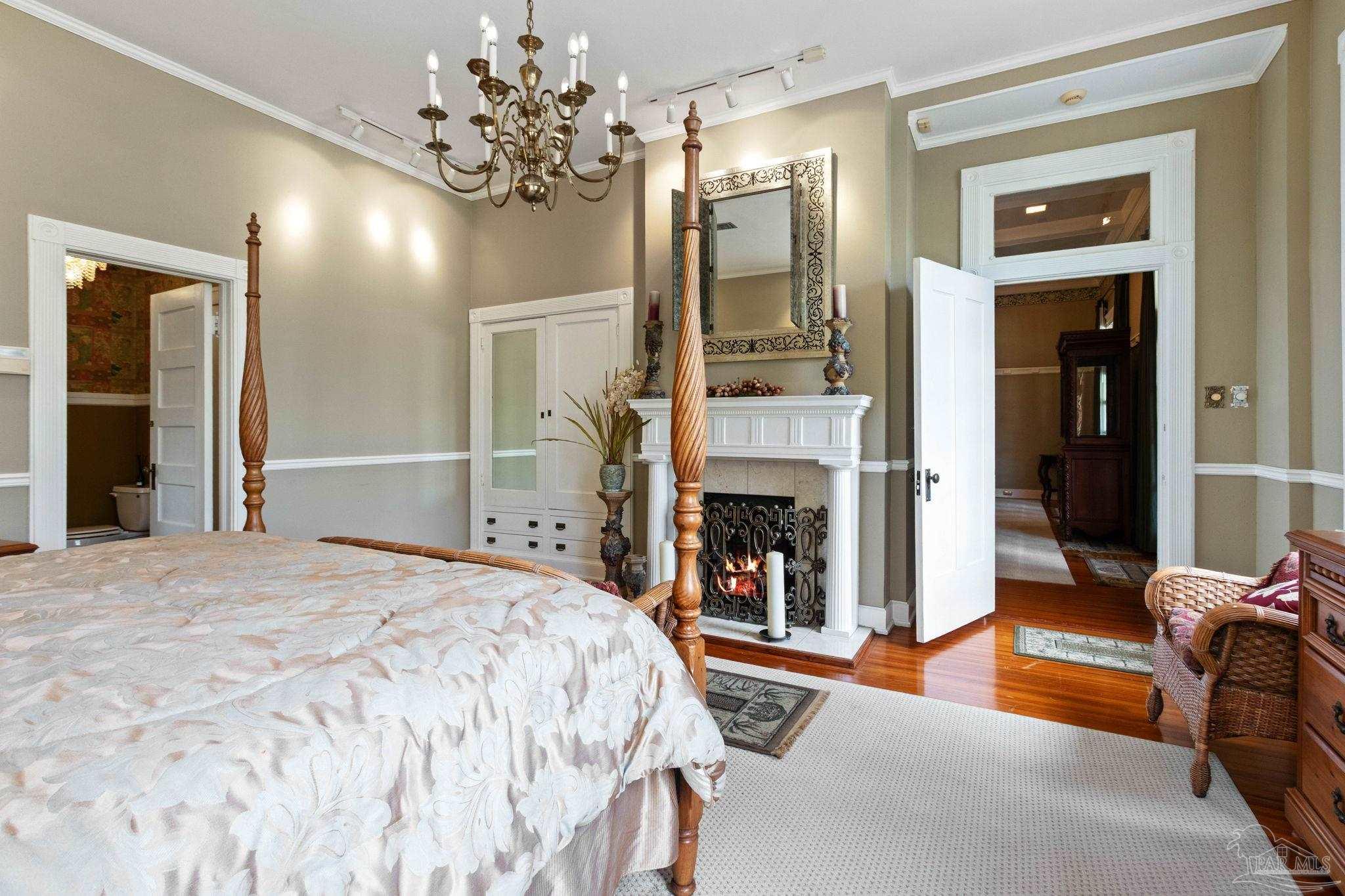 1701 Sowell Road Brewton, AL 36426 - Photo 51 of 72 a spacious bedroom with a bed and a fireplace