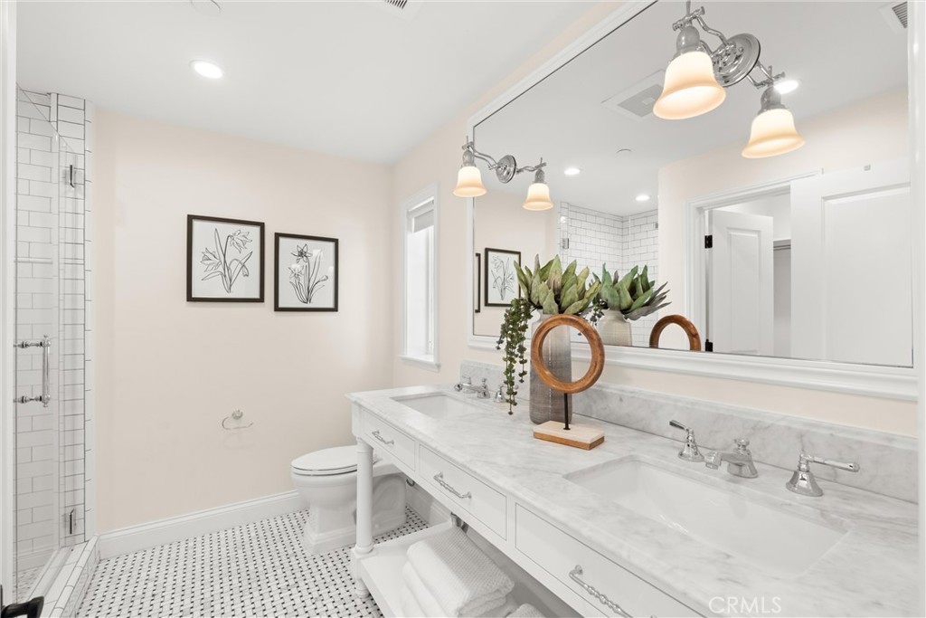 503 Hazel Drive Corona del Mar, CA 92625 - Photo 21 of 39 a bathroom with a sink a toilet and a mirror