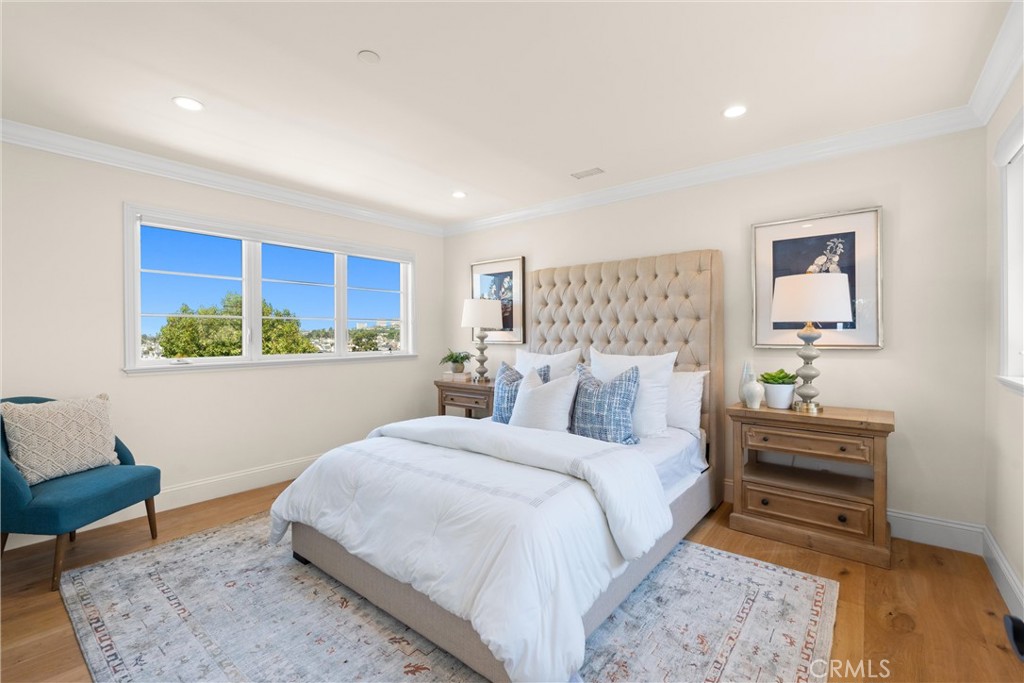 503 Hazel Drive Corona del Mar, CA 92625 - Photo 27 of 39 a bedroom with a bed and a painting on the wall