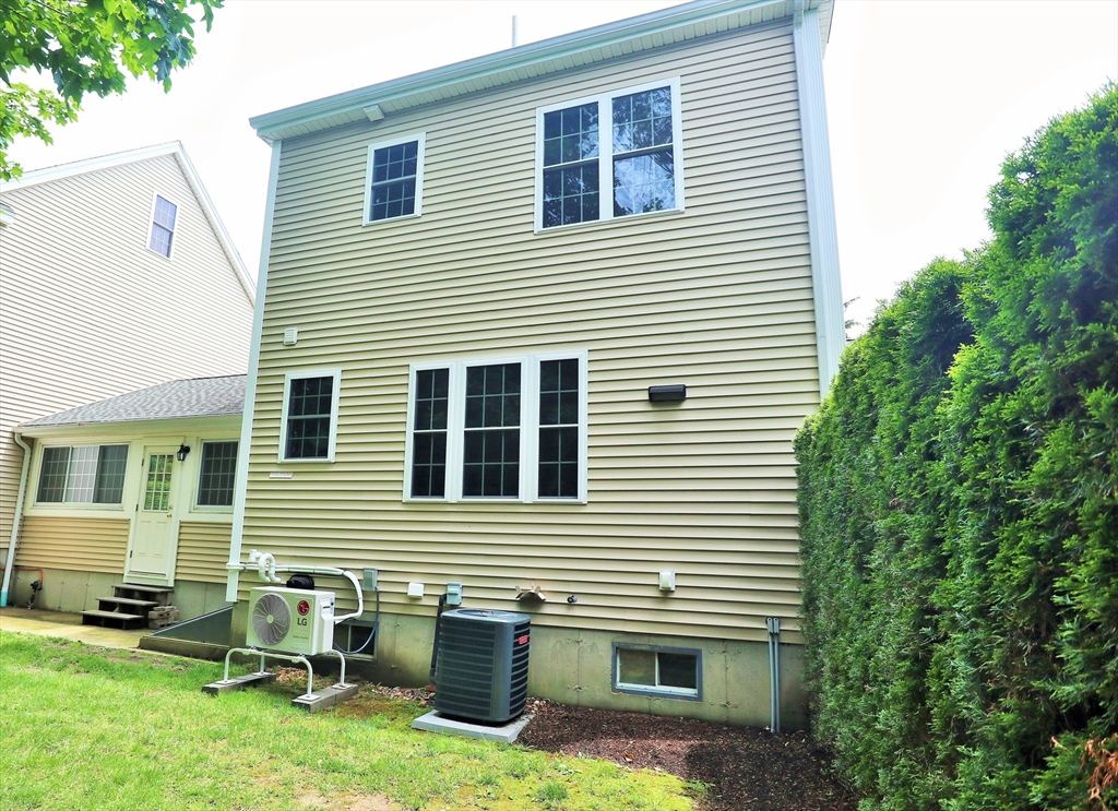 90 Central Street, Unit 2 East Bridgewater, MA 02333 - Photo 16 of 16 a view of a house with a yard and sitting area