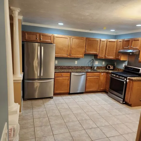 a kitchen with stainless steel appliances granite countertop a refrigerator sink and cabinets