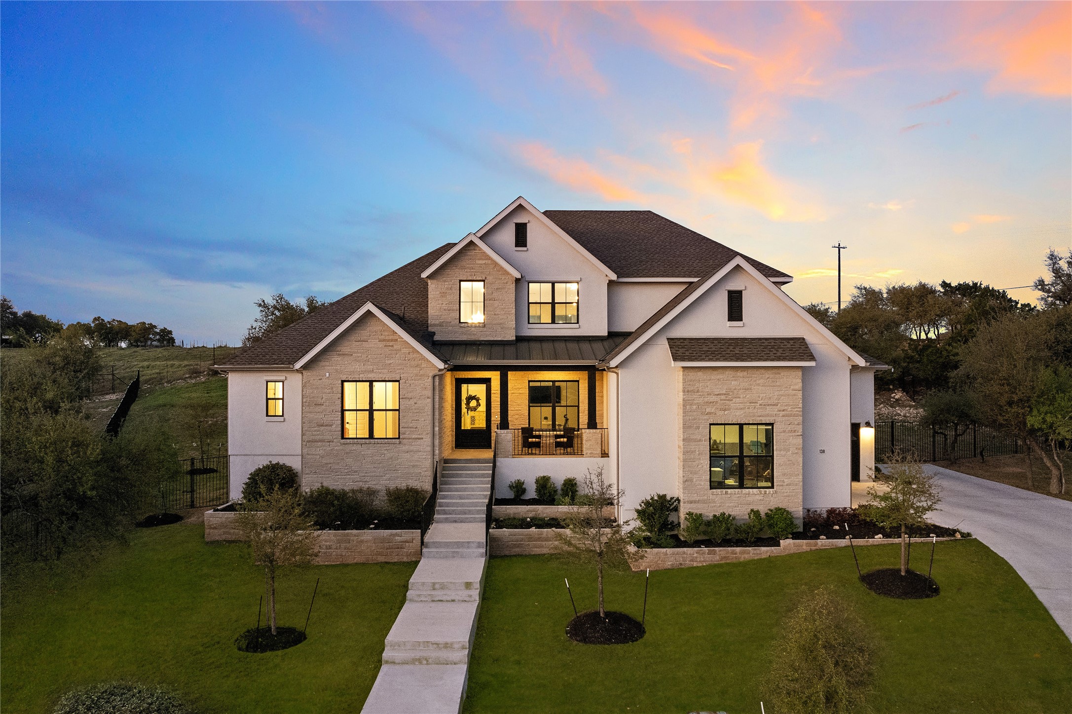 138 Yellow Bell Run Dripping Springs, TX 78620 - Photo 1 of 1 Modern farmhouse style home with a front yard, covered porch, a standing seam roof, and roof with shingles