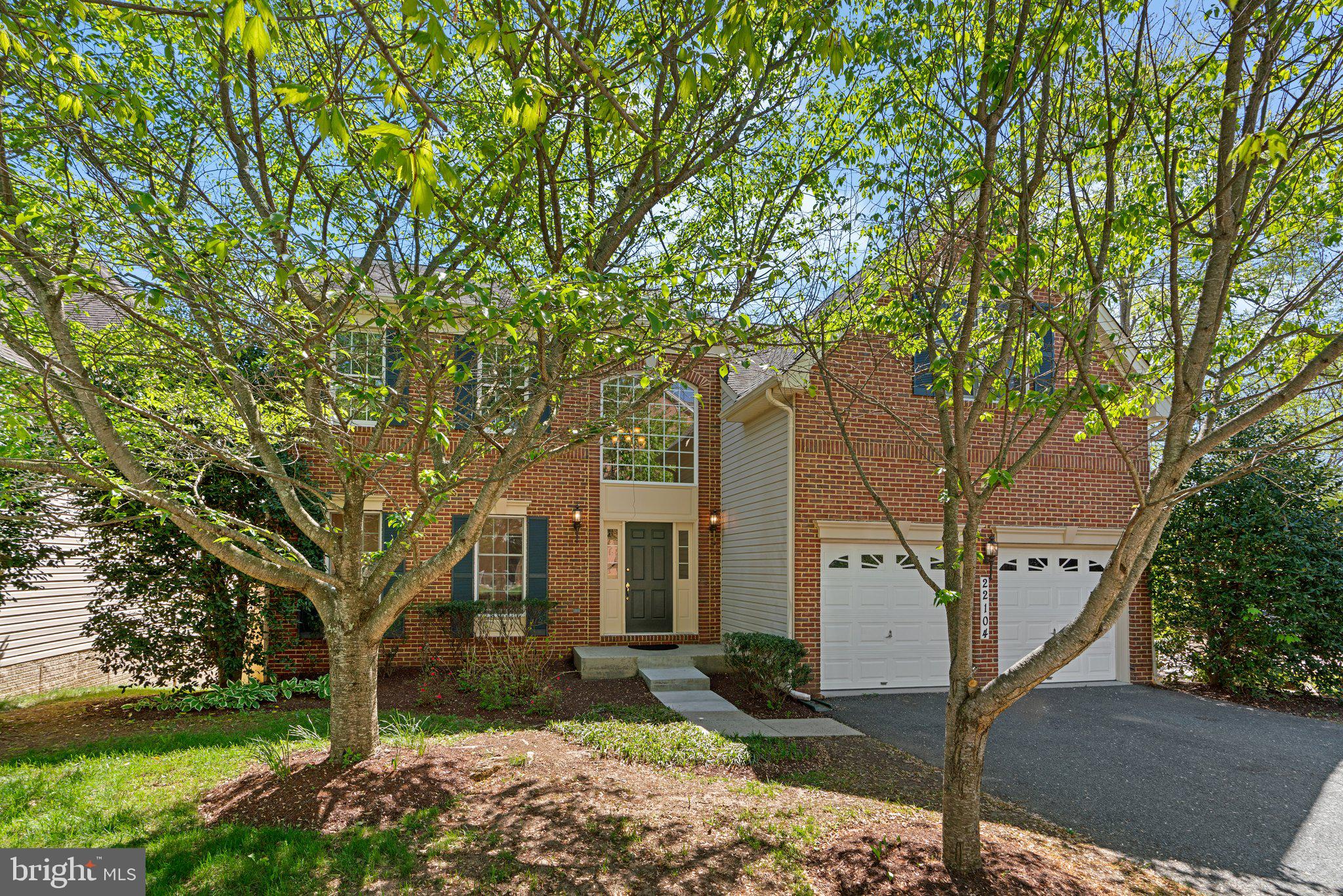 22104 Ginger Tree Way Clarksburg, MD 20871 - Photo 1 of 57 a tree in front of a white house