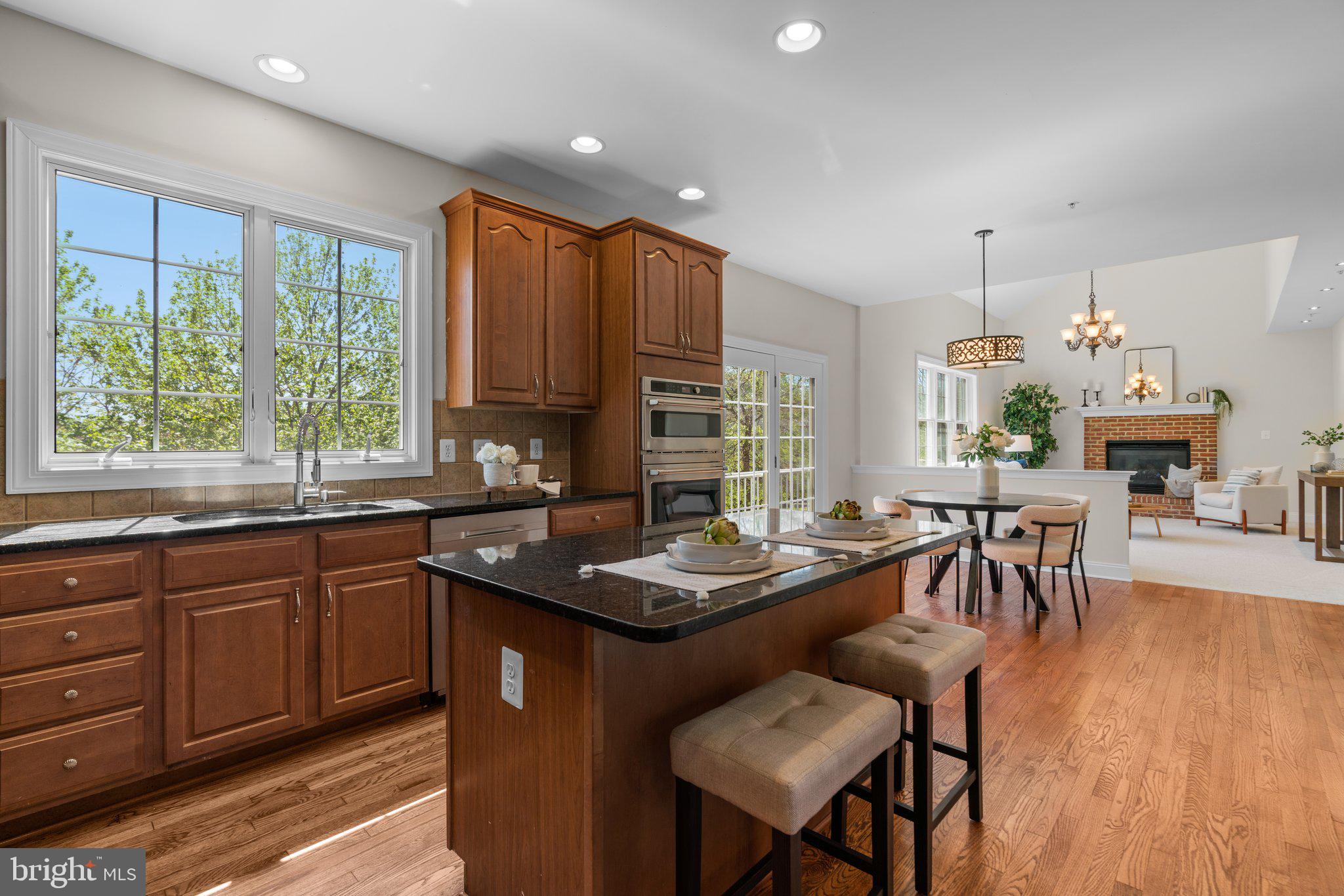 22104 Ginger Tree Way Clarksburg, MD 20871 - Photo 15 of 57 a kitchen with granite countertop kitchen island dining table and chairs