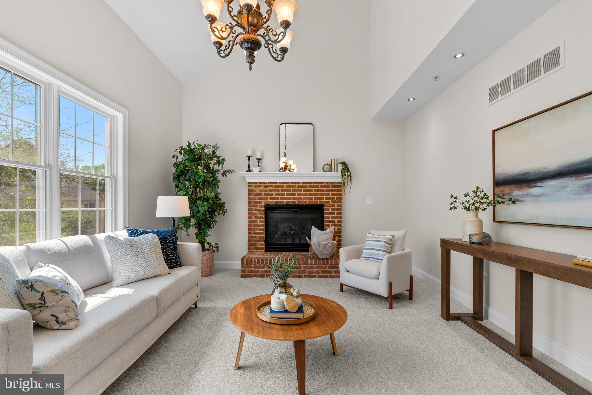 22104 Ginger Tree Way Clarksburg, MD 20871 - Photo 20 of 57 a living room with furniture a rug and a fireplace