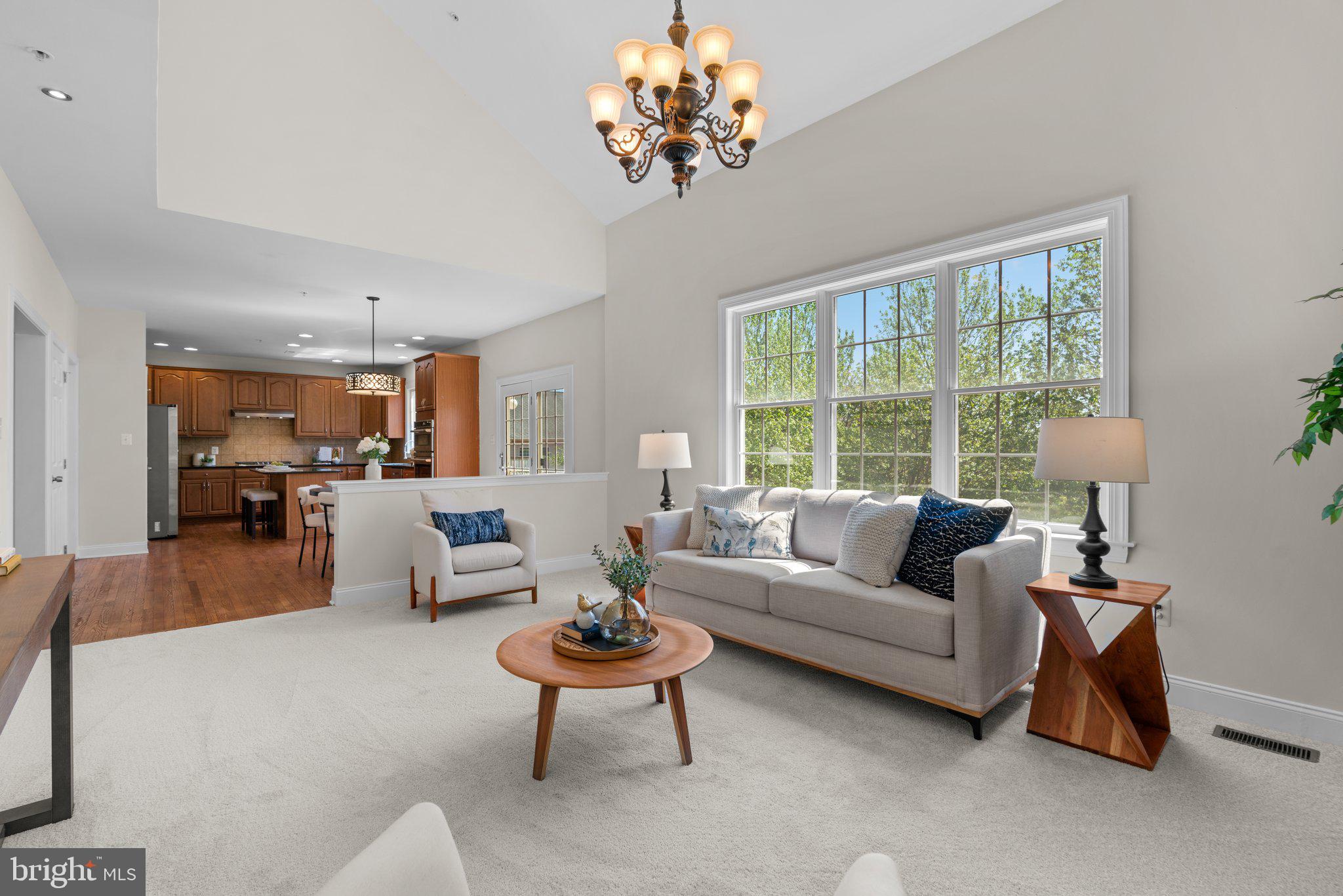 22104 Ginger Tree Way Clarksburg, MD 20871 - Photo 22 of 57 a living room with furniture a chandelier and a large window