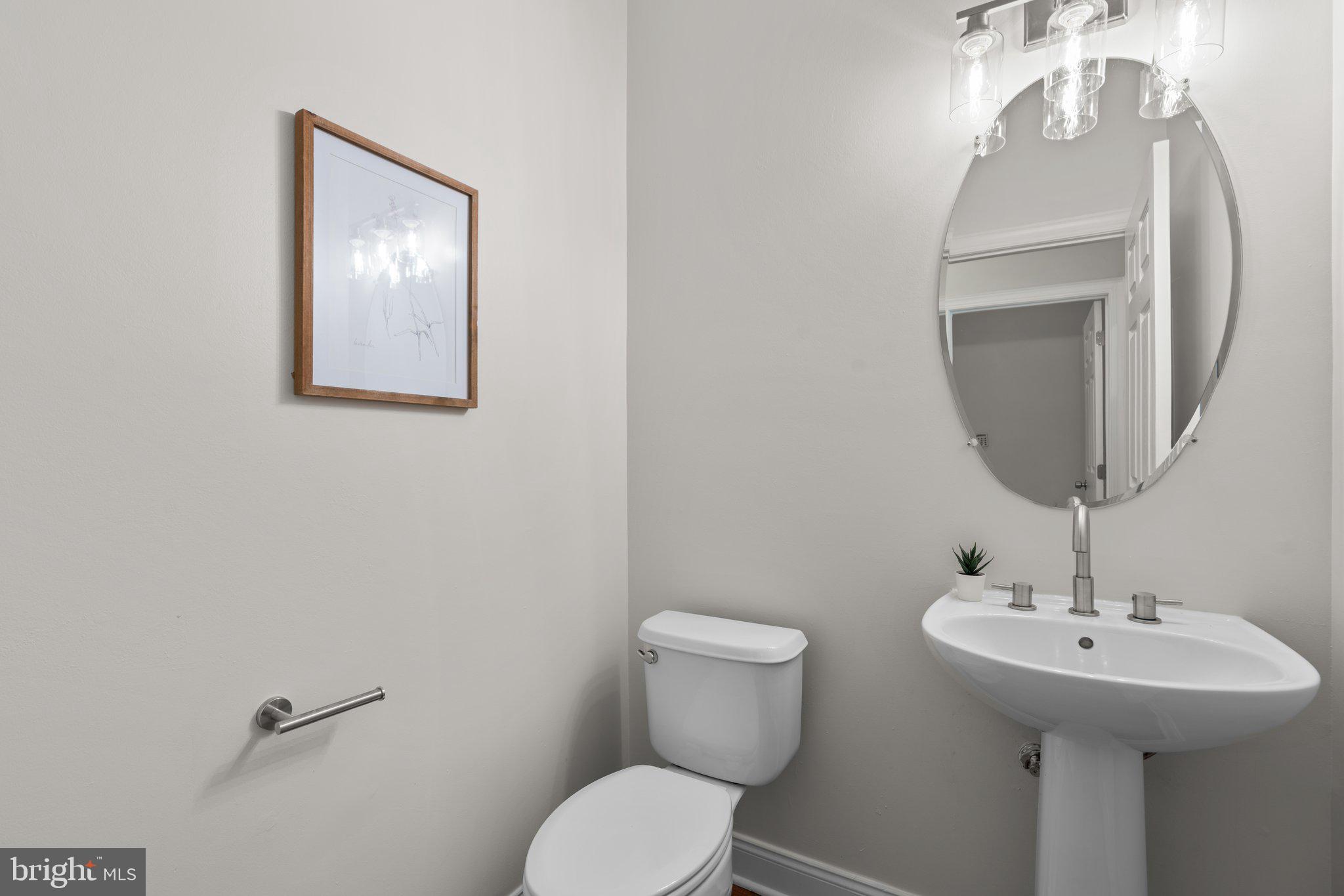 22104 Ginger Tree Way Clarksburg, MD 20871 - Photo 26 of 57 a bathroom with a toilet a sink and mirror