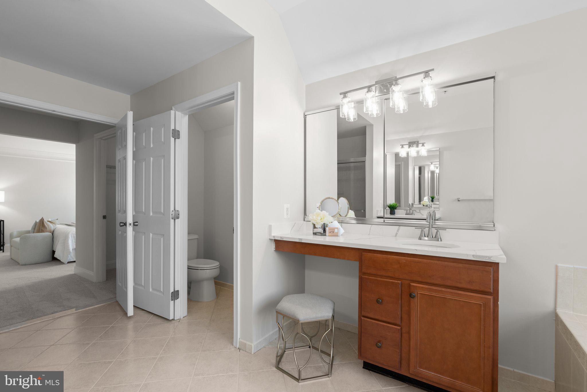 22104 Ginger Tree Way Clarksburg, MD 20871 - Photo 39 of 57 a bathroom with a double vanity sink and mirror