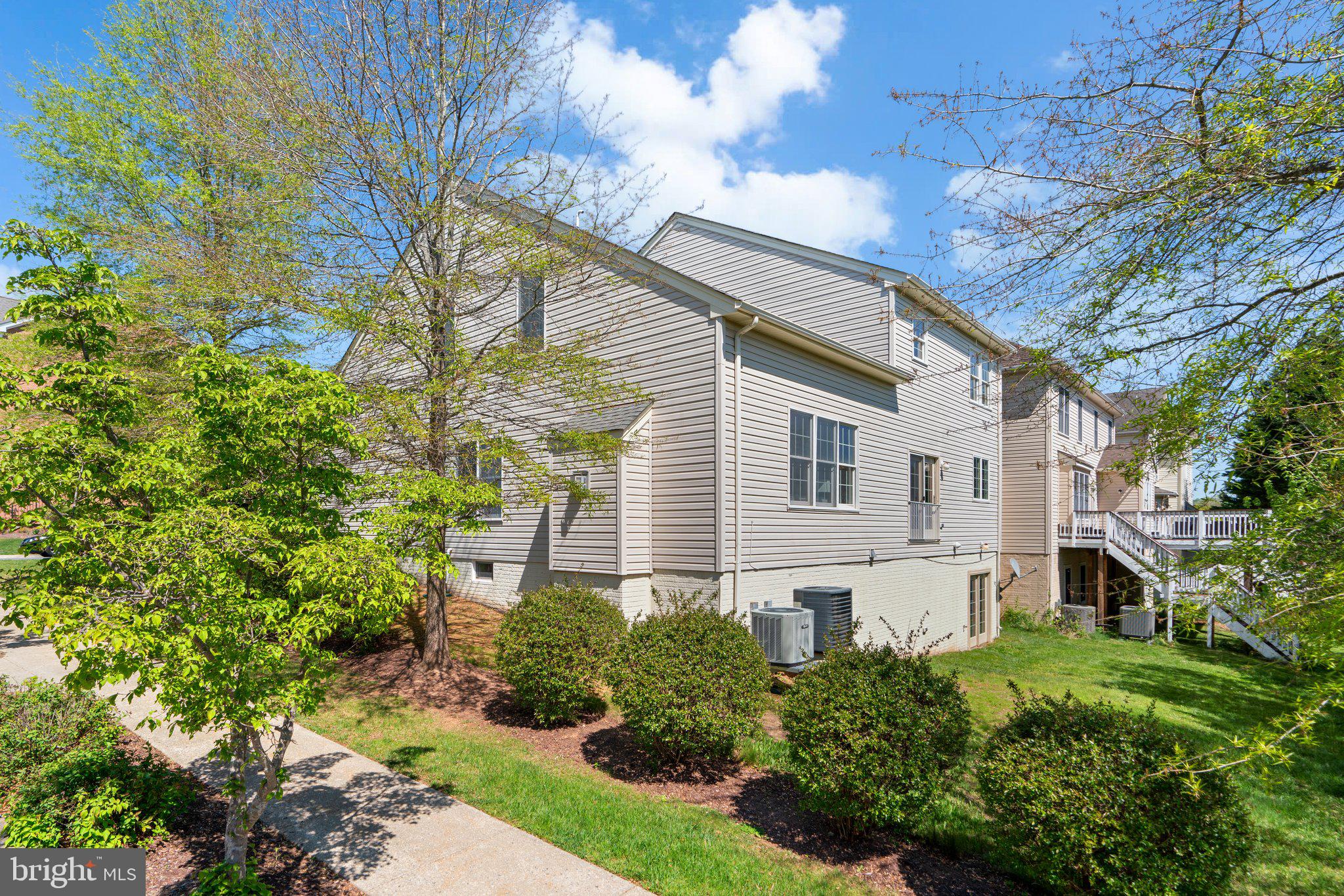 22104 Ginger Tree Way Clarksburg, MD 20871 - Photo 55 of 57 a view of a house with a yard and plants