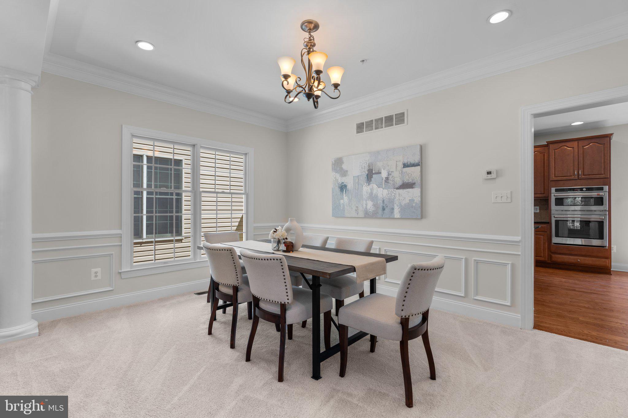 22104 Ginger Tree Way Clarksburg, MD 20871 - Photo 8 of 57 a view of a dining room with furniture and wooden floor