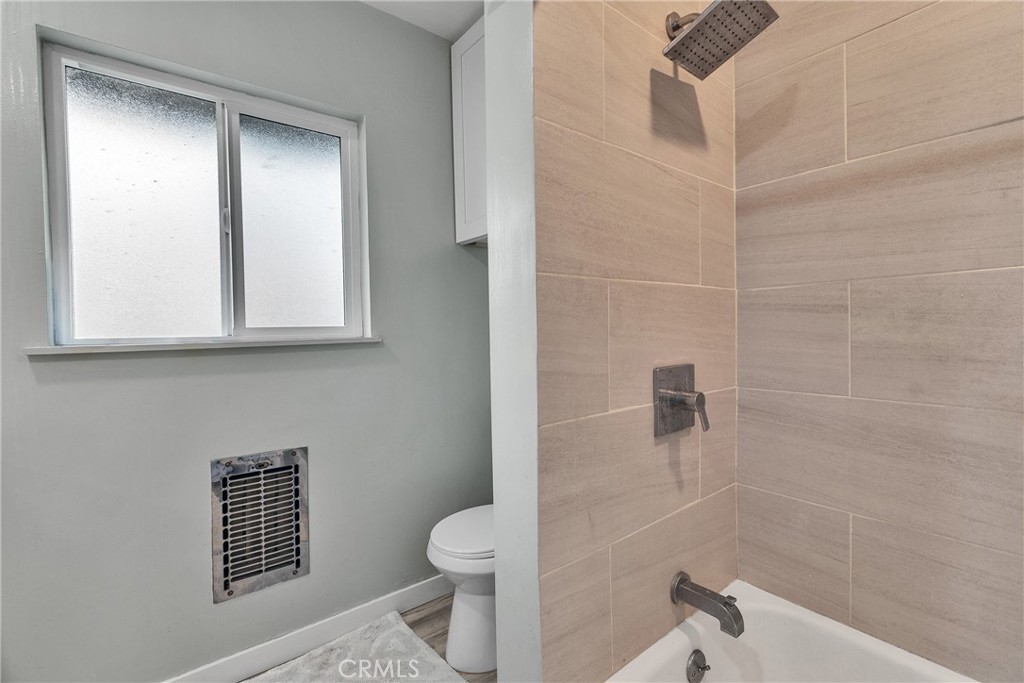 5121 Sierra Street Riverside, CA 92504 - Photo 26 of 34 a bathroom with a toilet a sink and shower