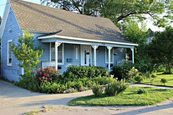 a front view of a house with garden