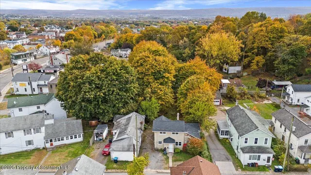 an aerial view of multiple houses with a yard
