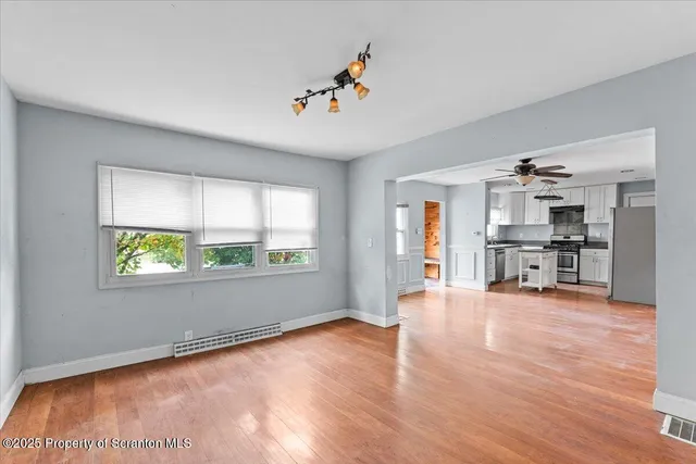 wooden floor in an empty room with a window