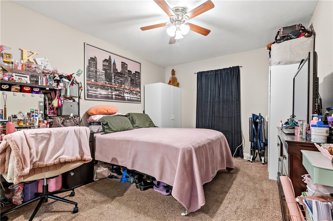 112 Ehlinger Drive Bryan, TX 77801 - Photo 15 of 18 a bedroom with a bed and a chandelier
