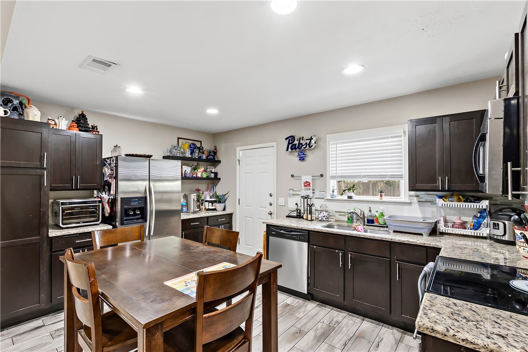 112 Ehlinger Drive Bryan, TX 77801 - Photo 7 of 18 a kitchen with lots of counter top space and stainless steel appliances