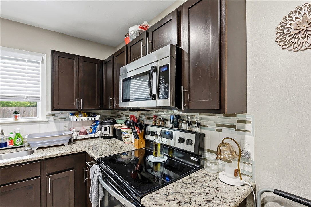 112 Ehlinger Drive Bryan, TX 77801 - Photo 8 of 18 a kitchen with a sink stove and cabinets