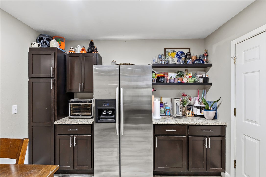 112 Ehlinger Drive Bryan, TX 77801 - Photo 10 of 18 a kitchen with a refrigerator and cabinets