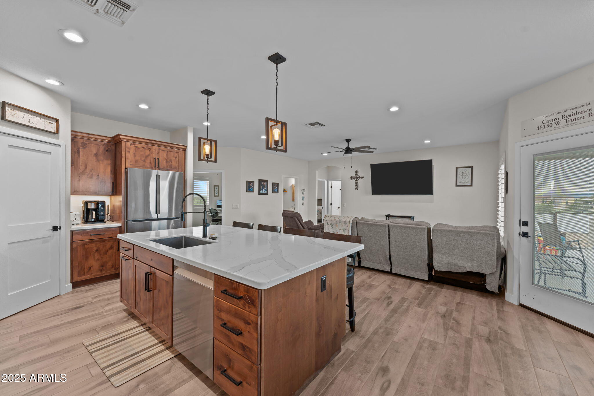 46130 West Trotter Road Wickenburg, AZ 85390 - Photo 11 of 55 a large kitchen with stainless steel appliances a stove top oven a sink dishwasher a oven with a dining table and chairs