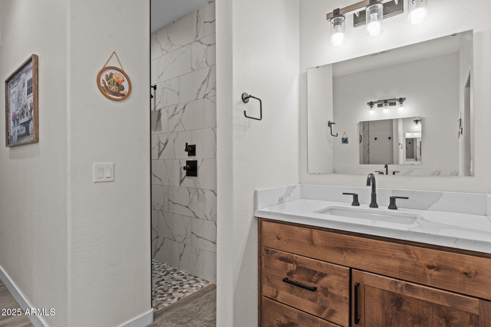 46130 West Trotter Road Wickenburg, AZ 85390 - Photo 21 of 55 a bathroom with a sink a mirror and a shower
