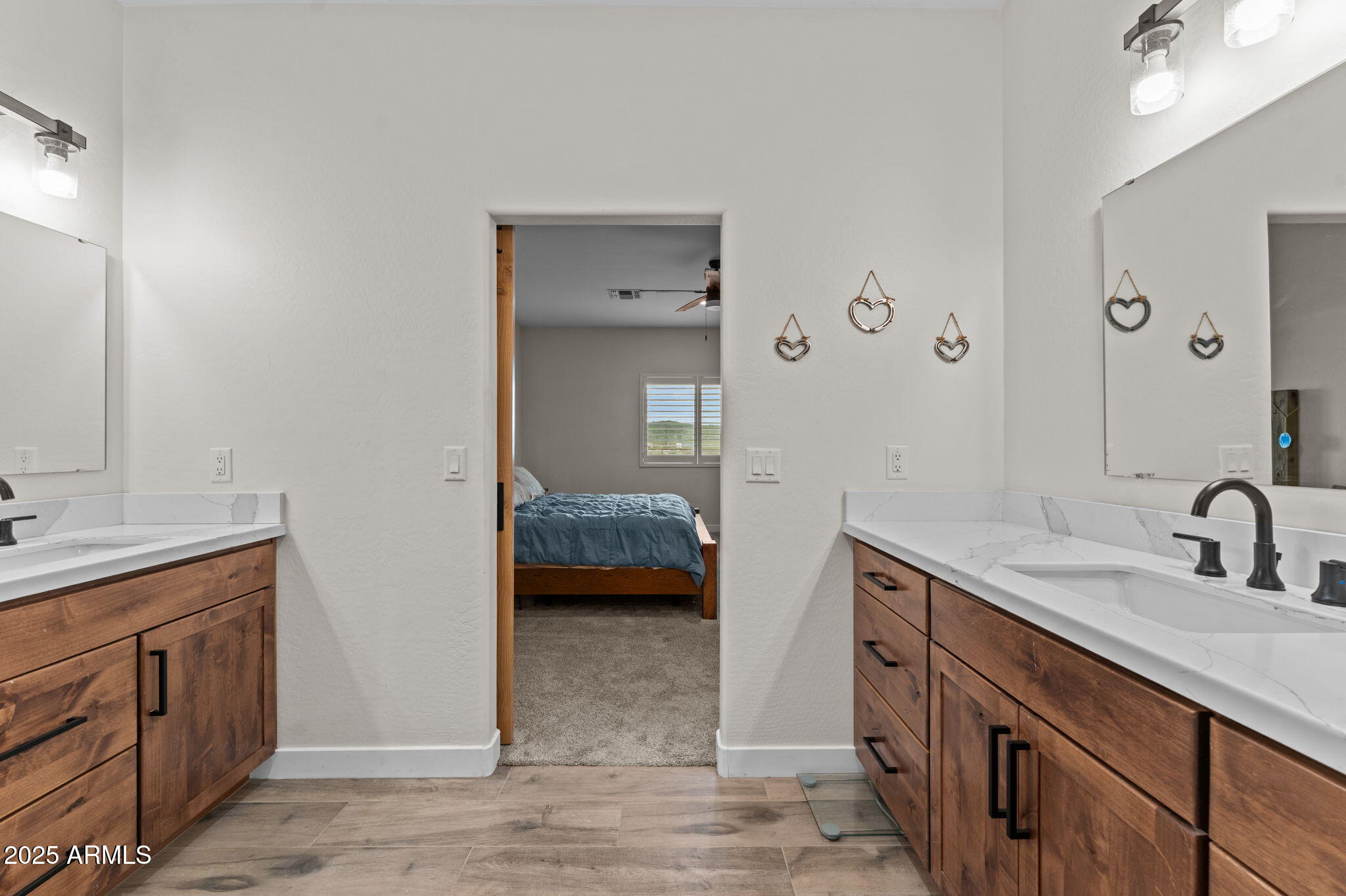 46130 West Trotter Road Wickenburg, AZ 85390 - Photo 22 of 55 a en suite bathroom with a sink and a large mirror