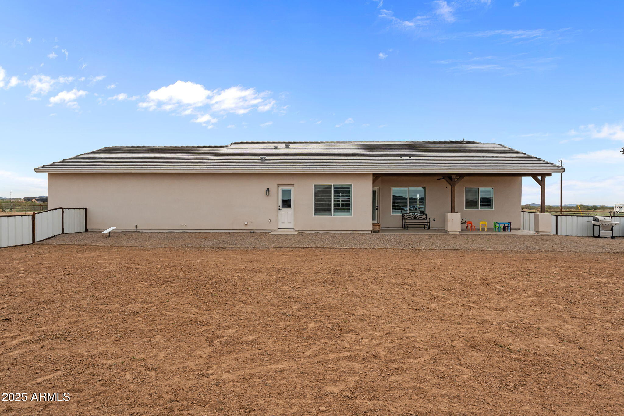46130 West Trotter Road Wickenburg, AZ 85390 - Photo 52 of 55 a front view of house with yard and trees in the background