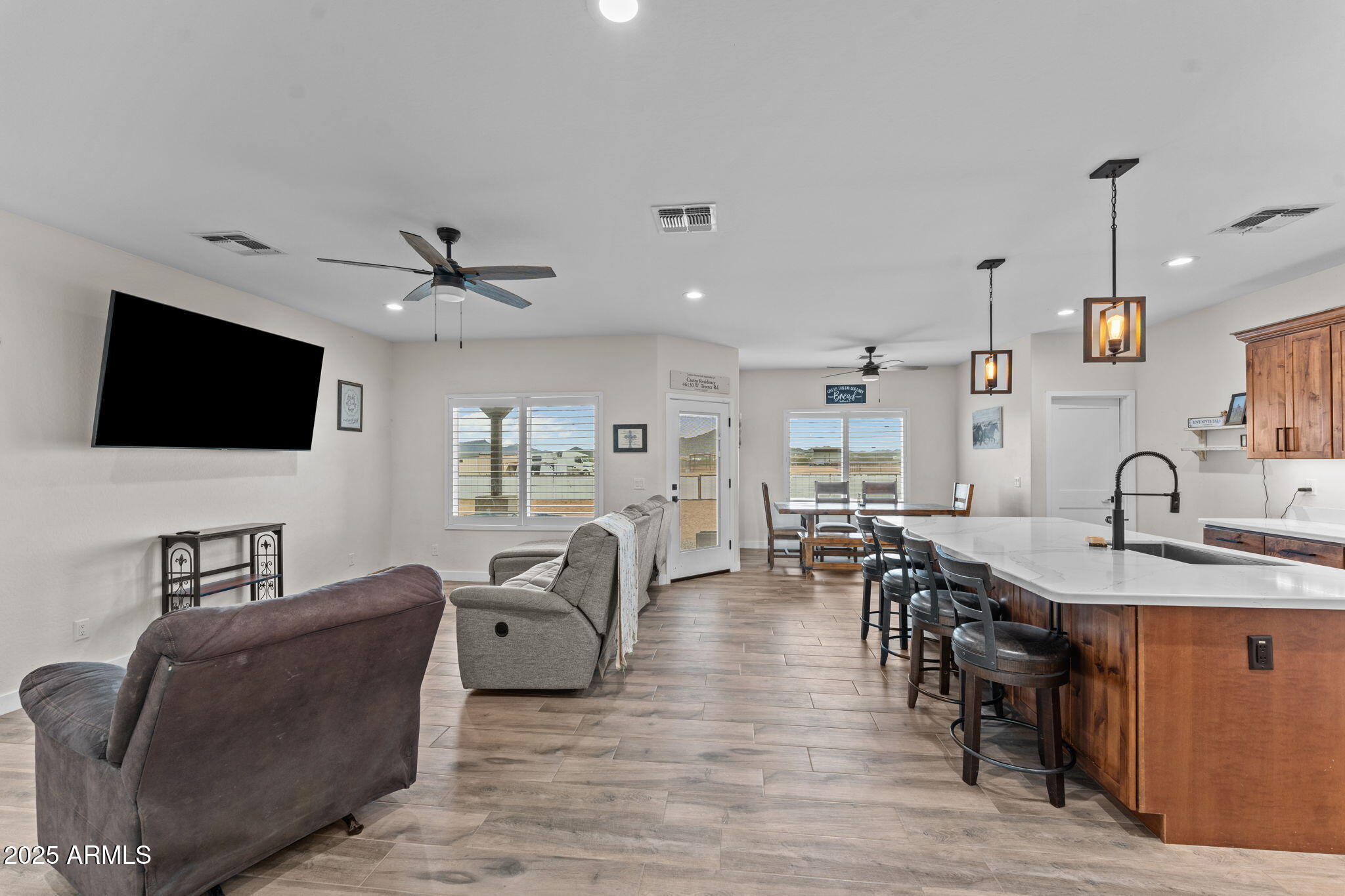 46130 West Trotter Road Wickenburg, AZ 85390 - Photo 6 of 55 a living room with furniture kitchen view and a flat screen tv