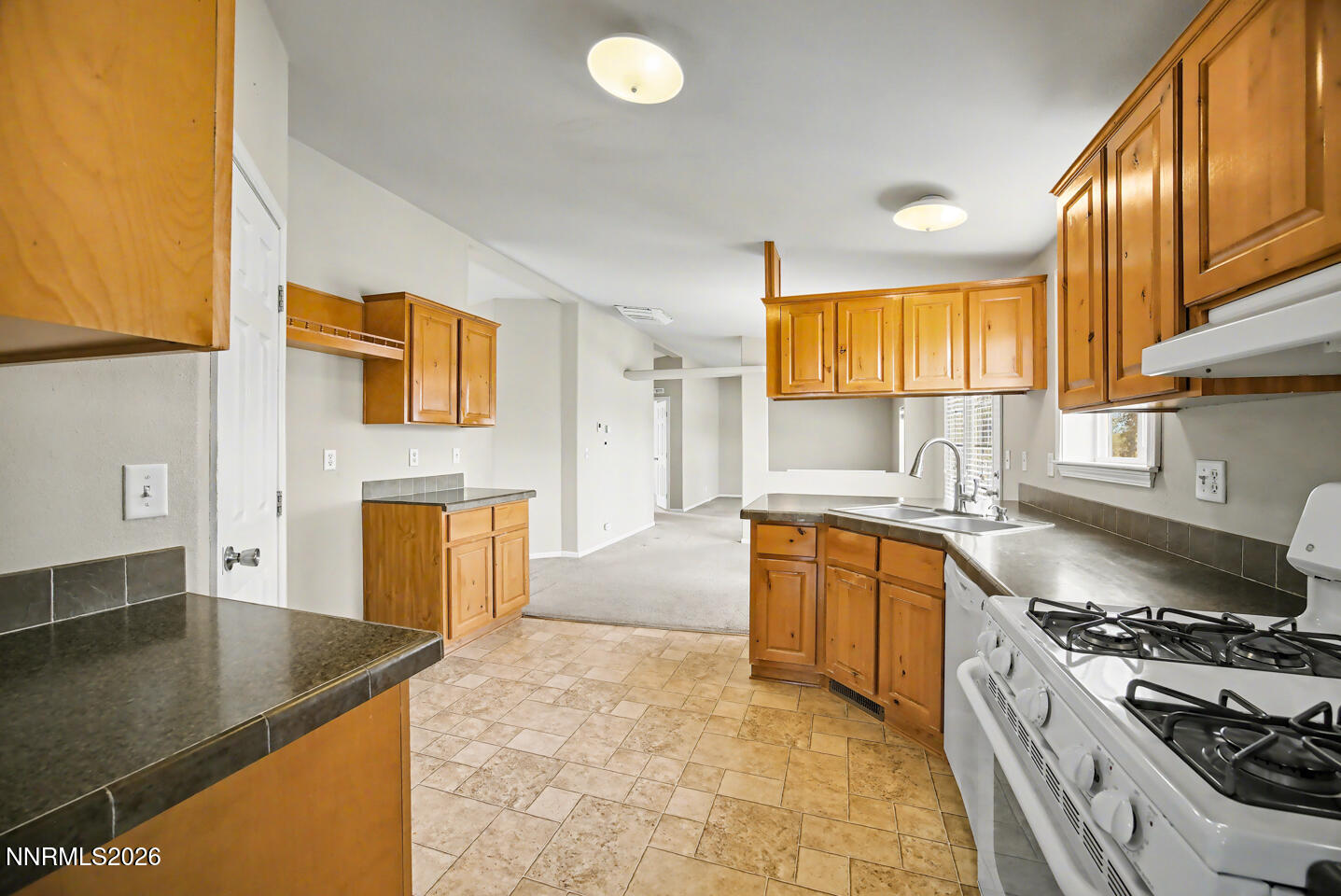 4141 Schindler Road Fallon, NV 89406 - Photo 7 of 25 a kitchen with stainless steel appliances granite countertop a sink stove and refrigerator