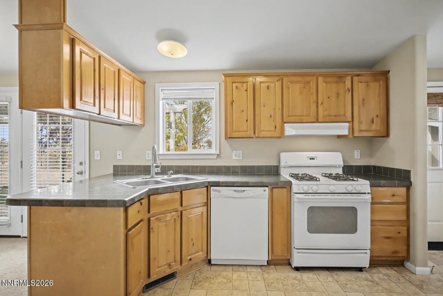 4141 Schindler Road Fallon, NV 89406 - Photo 9 of 25 a kitchen with granite countertop white cabinets and white appliances