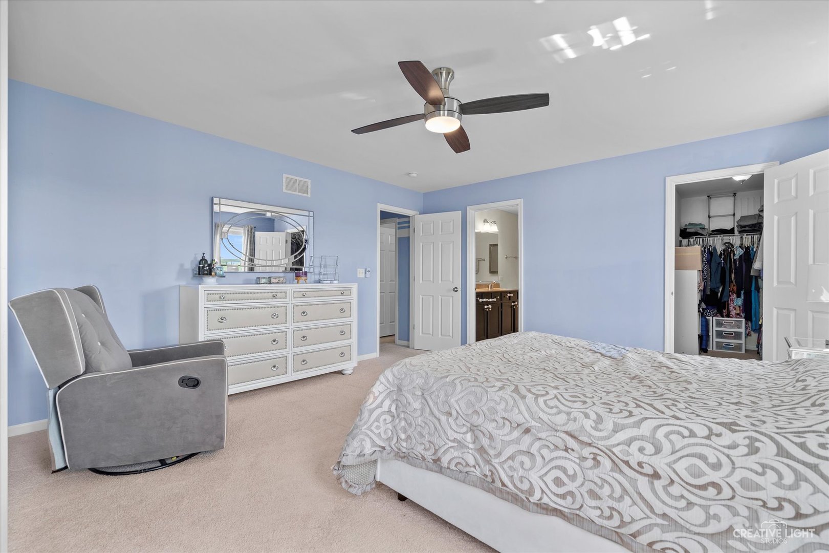 2824 Church Road Aurora, IL 60502 - Photo 13 of 20 a bedroom with a large bed and a chandelier