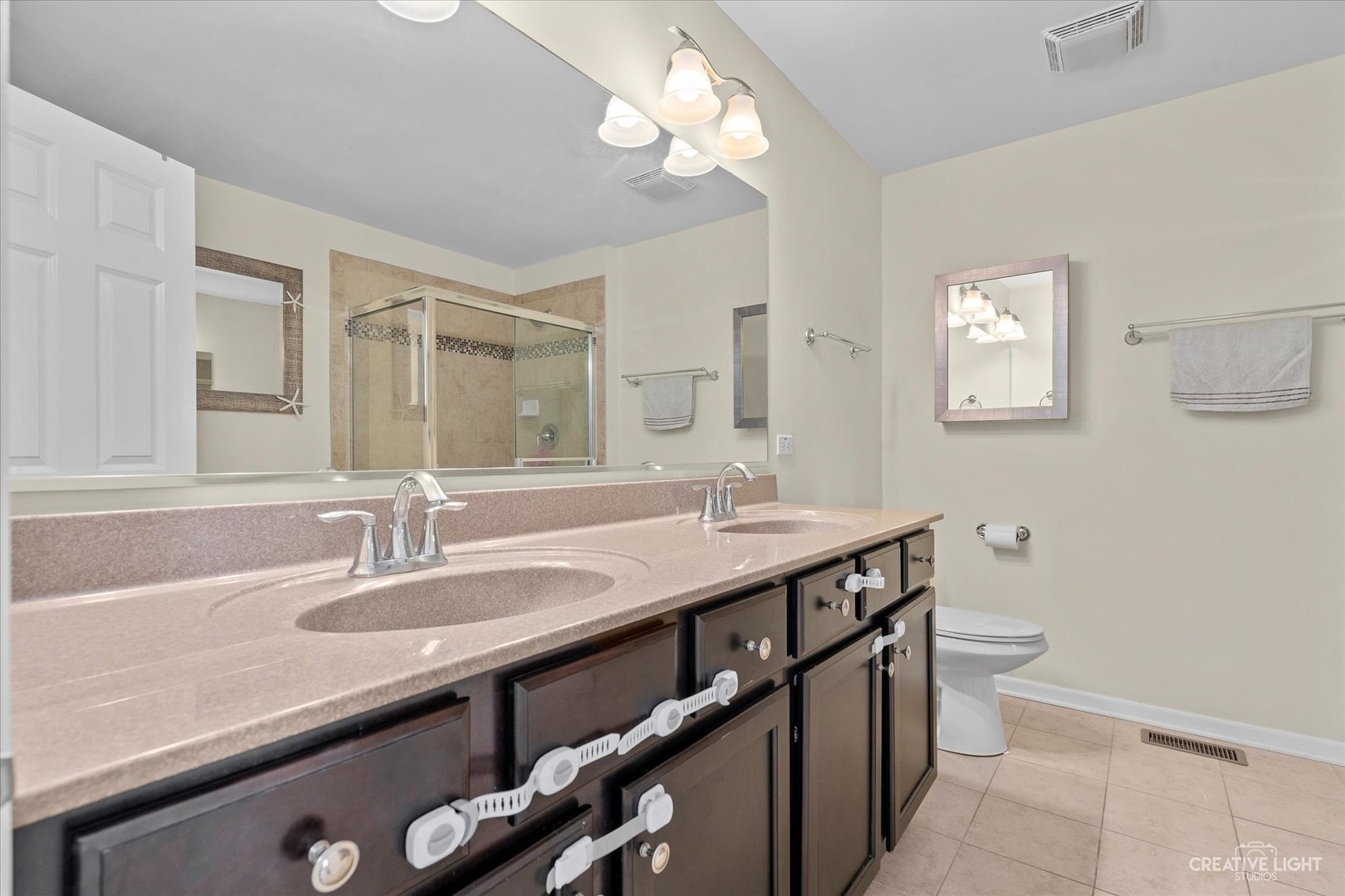 2824 Church Road Aurora, IL 60502 - Photo 14 of 20 a bathroom with a sink a toilet a mirror and shower