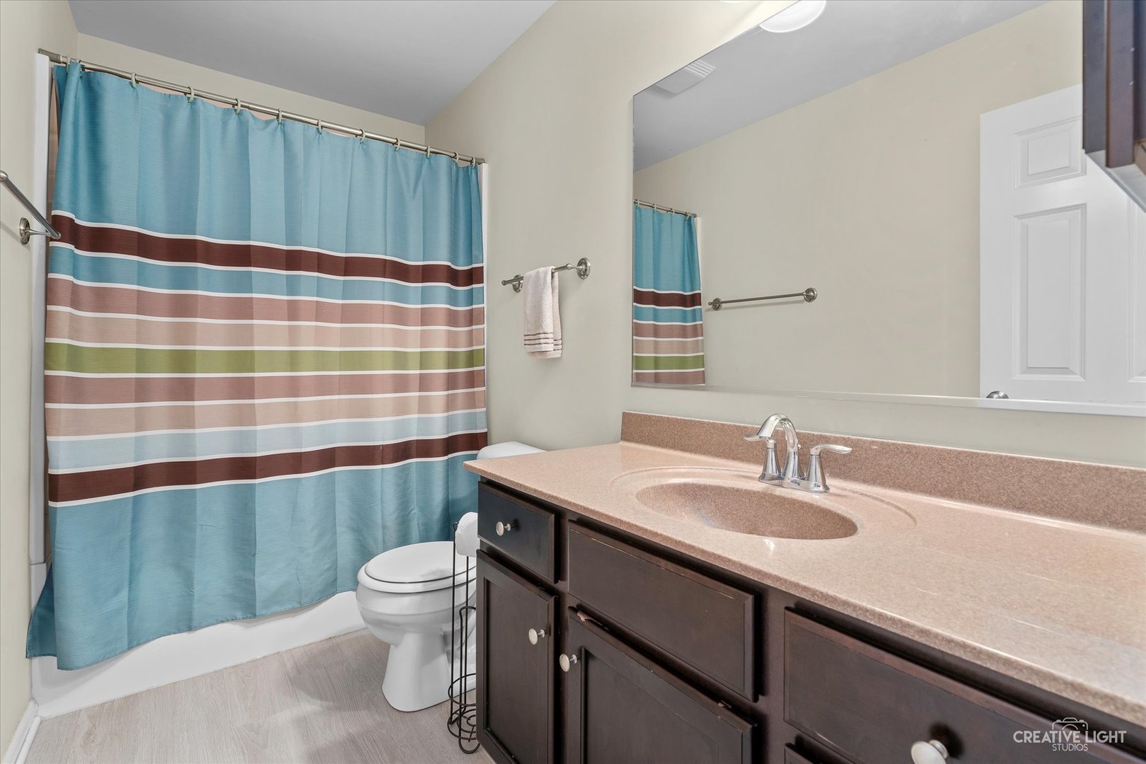 2824 Church Road Aurora, IL 60502 - Photo 16 of 20 a bathroom with a sink a toilet a shower and a mirror