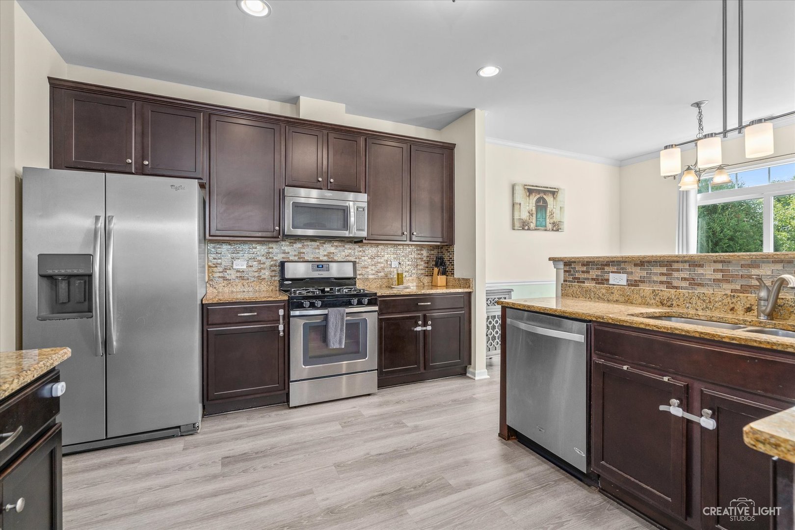 2824 Church Road Aurora, IL 60502 - Photo 7 of 20 a kitchen with granite countertop a refrigerator and a stove