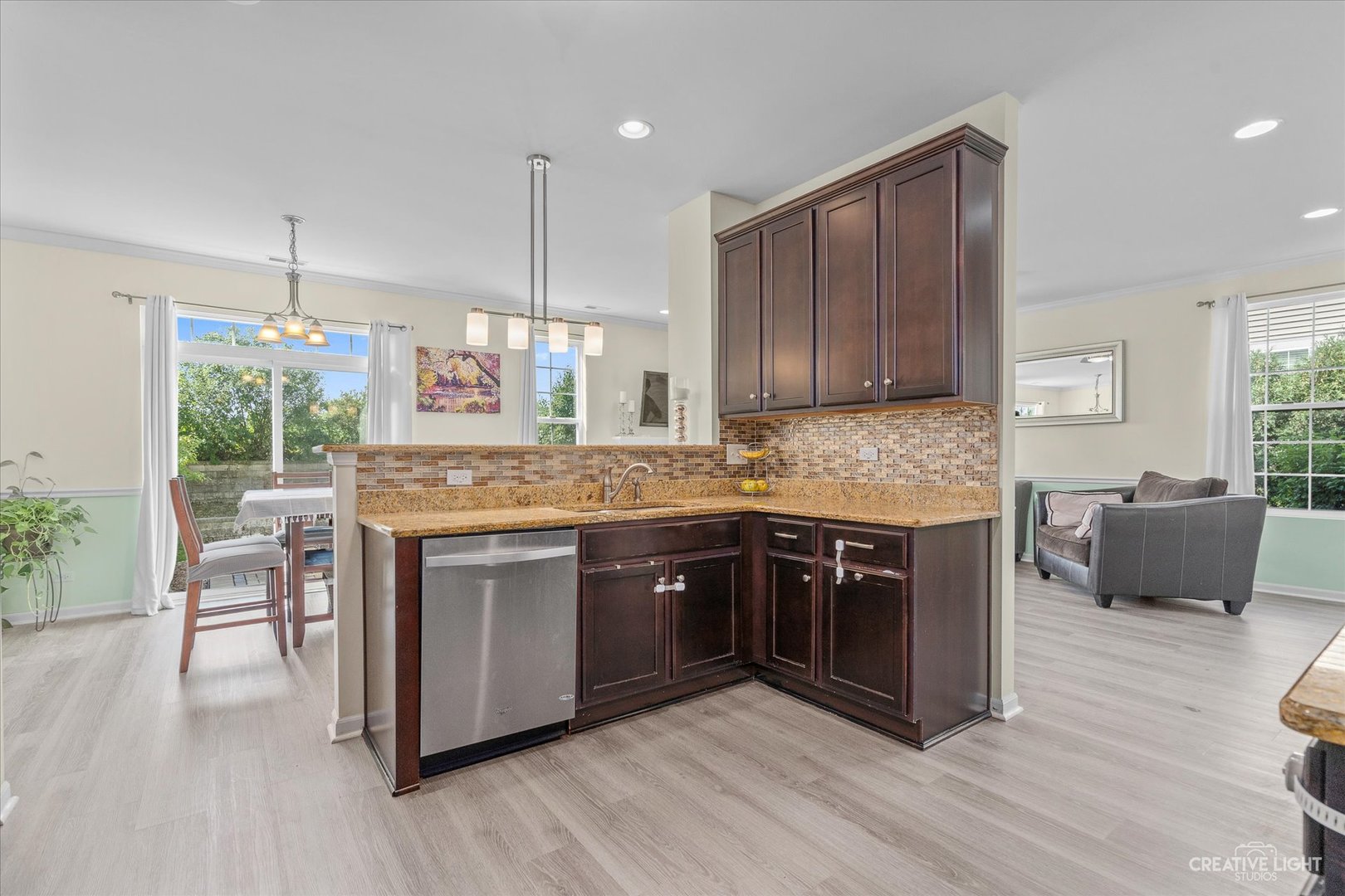 2824 Church Road Aurora, IL 60502 - Photo 8 of 20 a kitchen with kitchen island granite countertop wooden floors and white stainless steel appliances