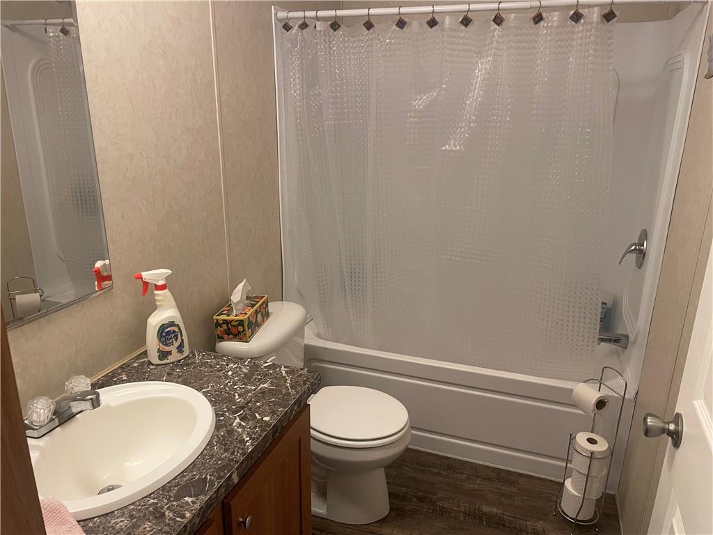 14624 Gilliland Road Linesville, PA 16424 - Photo 22 of 23 a bathroom with a granite countertop toilet sink and mirror