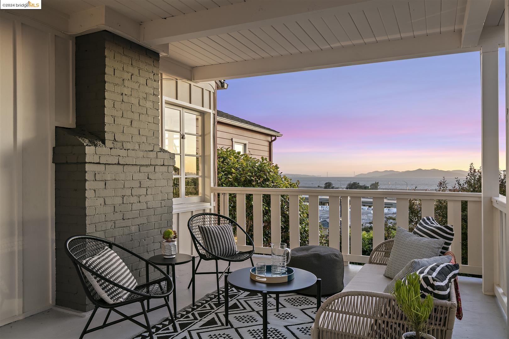 a view of a balcony with chairs and a potted plant