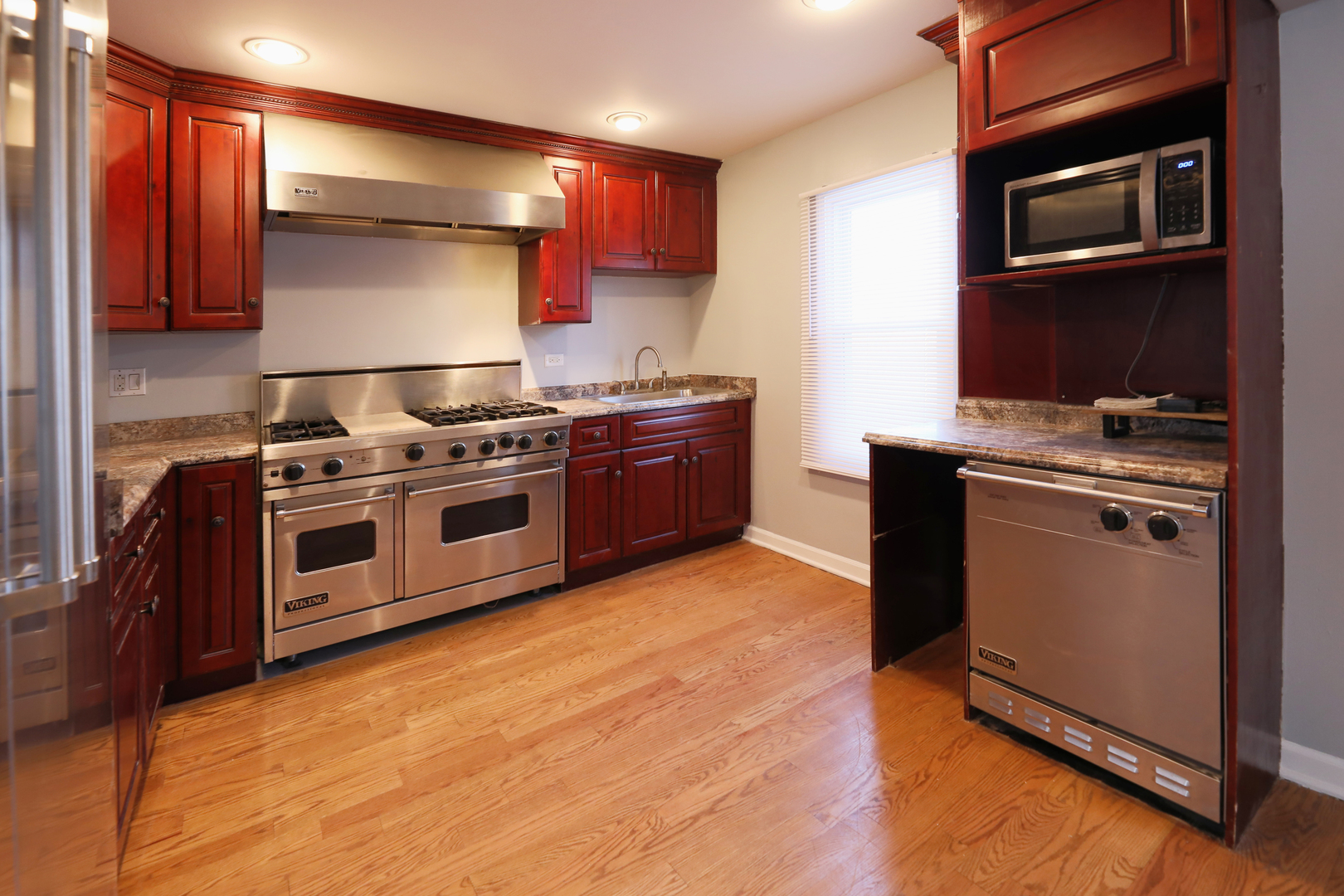 2015 Greenview Road Northbrook, IL 60062 - Photo 7 of 17 a kitchen with stainless steel appliances granite countertop a stove a sink and a microwave