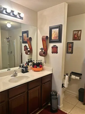 a bathroom with a sink mirror and toilet
